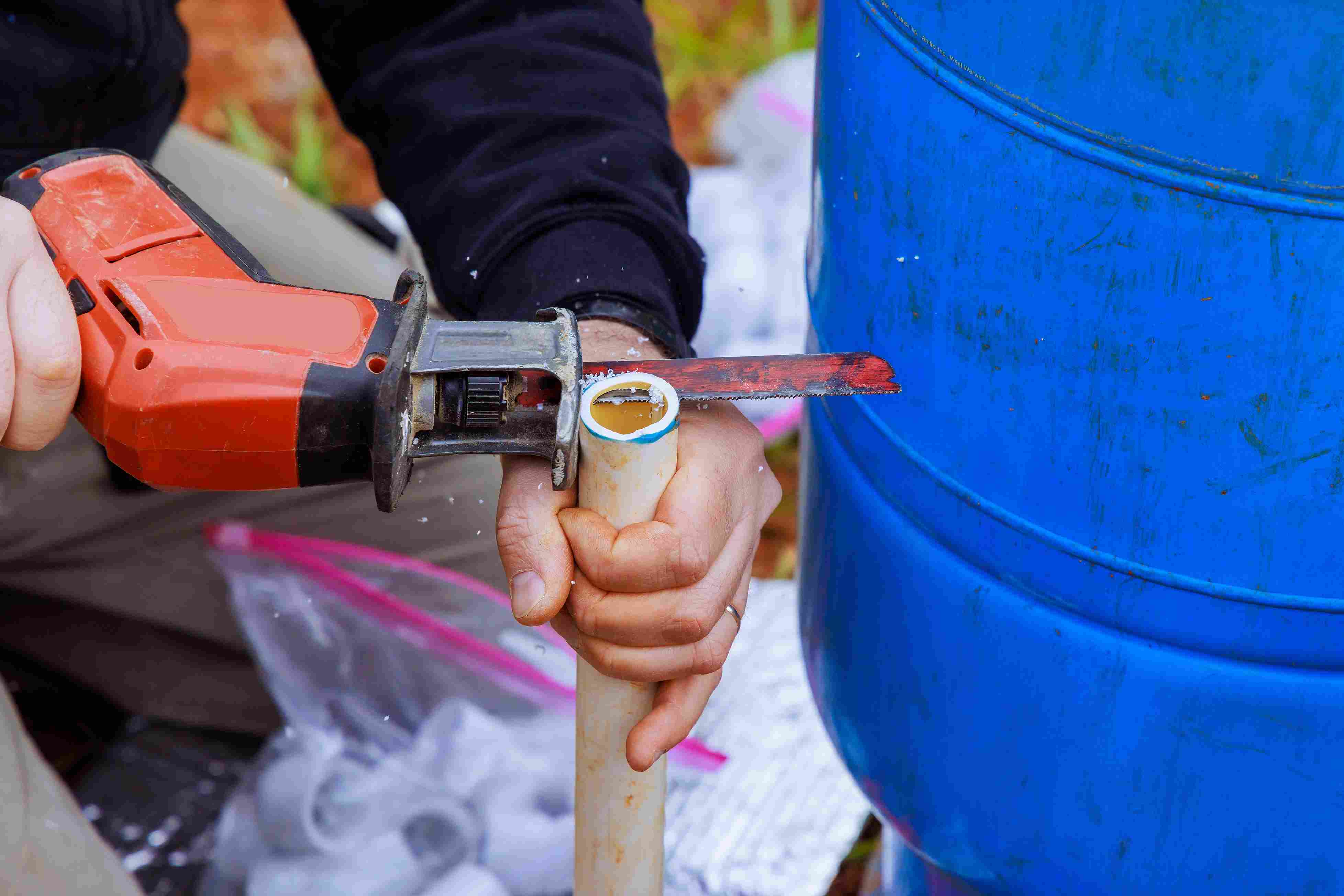 an-cuts-a-plastic-pvc-pipe-with-special-scissors
